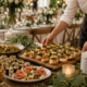 Caterer arranging canapés and buffet dishes before an event