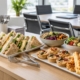 Sandwich platters, savoury tartlets and salad bowls arranged for an office lunch